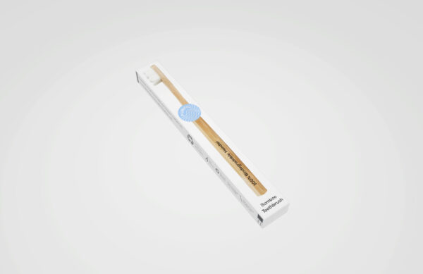 Purifiq Bamboo Toothbrush in packaging placed against white background in studio.